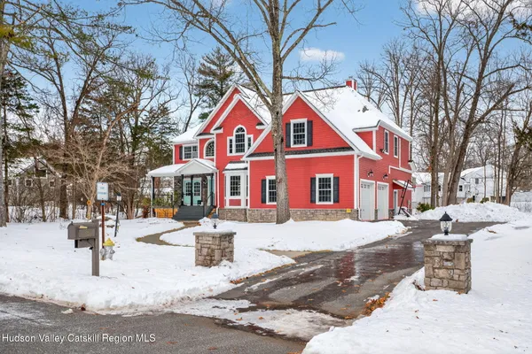 a front view of a building with snow on the road