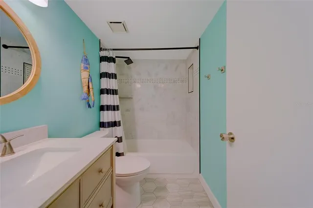 a dining room with furniture and a floor to ceiling window