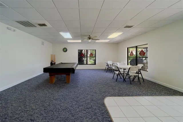 an aerial view of a house with a yard and basket ball court