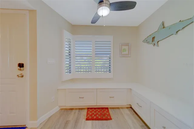 a kitchen that has a lot of cabinets in it and wooden floor
