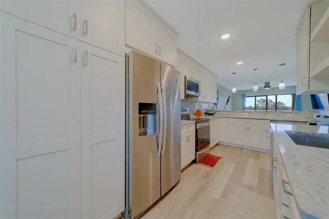 a kitchen with stainless steel appliances granite countertop a sink and a stove