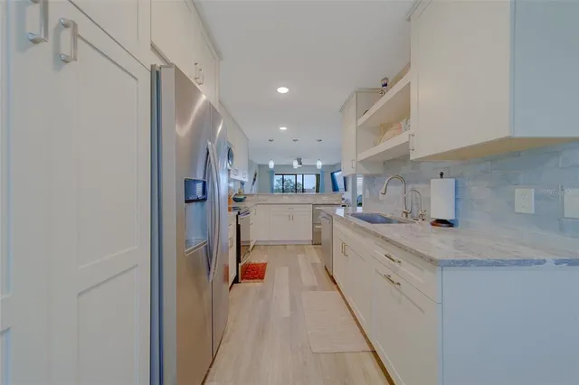 a kitchen with cabinets and window