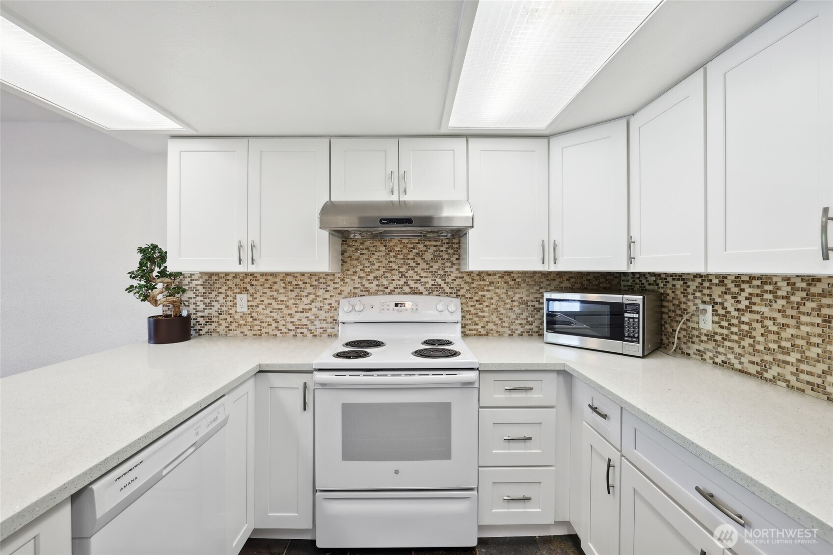 30831 13th Place South, Unit 13 Federal Way, WA 98003 - Photo 11 of 38 a kitchen with white cabinets and appliances