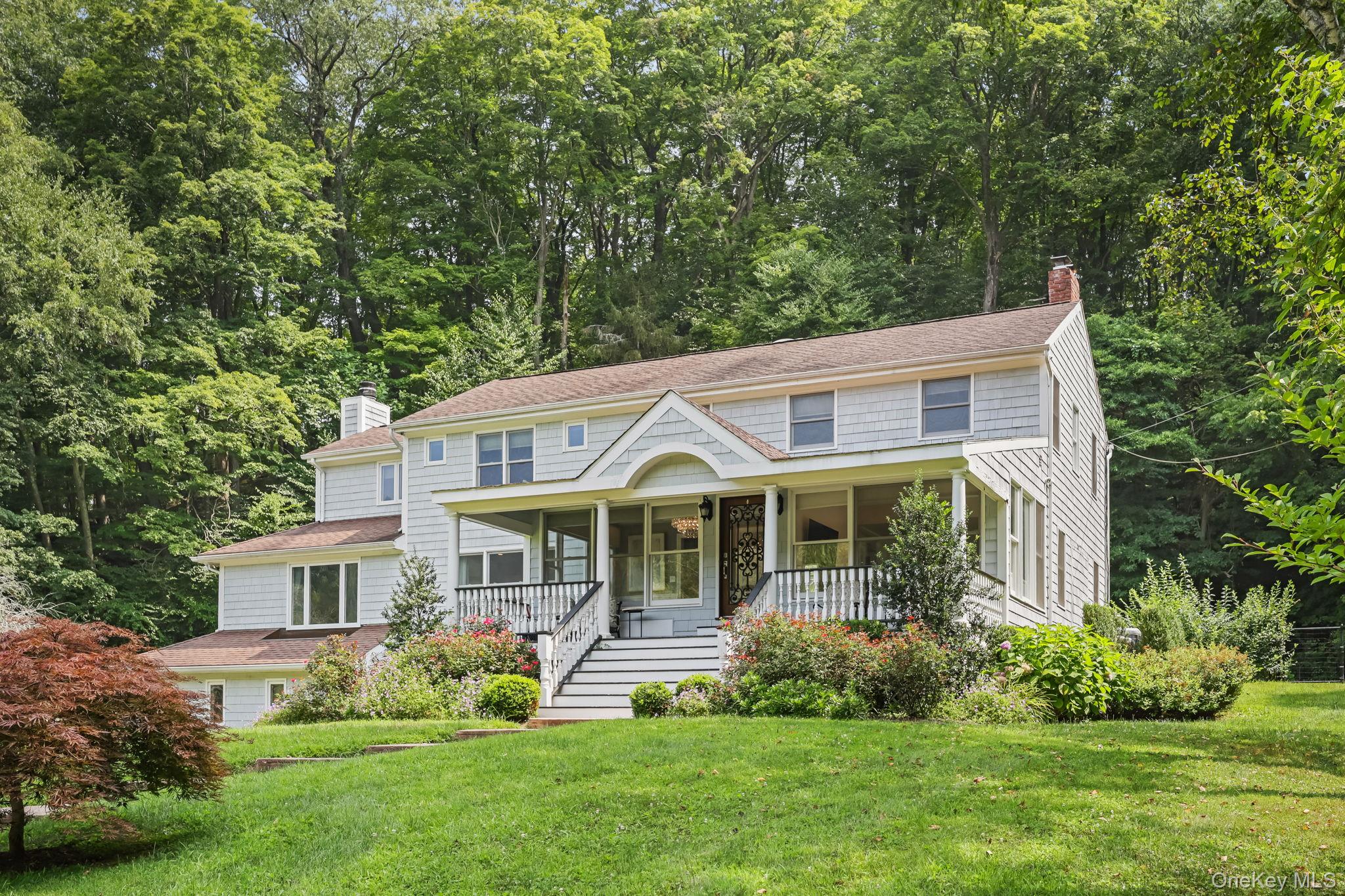 777 Armonk Road Mount Kisco, NY 10549 - Photo 1 of 1 a front view of a house with a yard table and chairs
