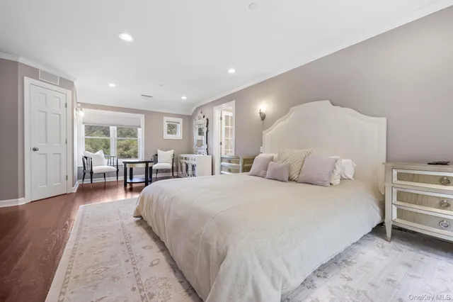 a spacious bedroom with a bed and a large window