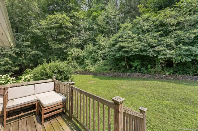 a view of a balcony with wooden floor and fence