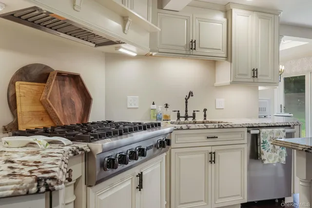 a kitchen with granite countertop a stove and a sink