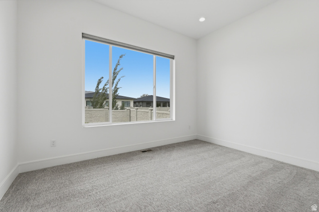 653 East Vandalay Lane Draper, UT 84020 - Photo 28 of 61 Spacious room featuring a large window, recessed lighting, white walls, and light-toned carpeting