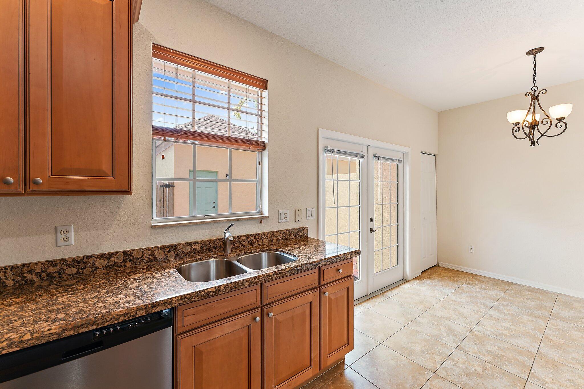 128 West Thatch Palm Circle Jupiter, FL 33458 - Photo 12 of 31 a kitchen that has a sink and cabinets
