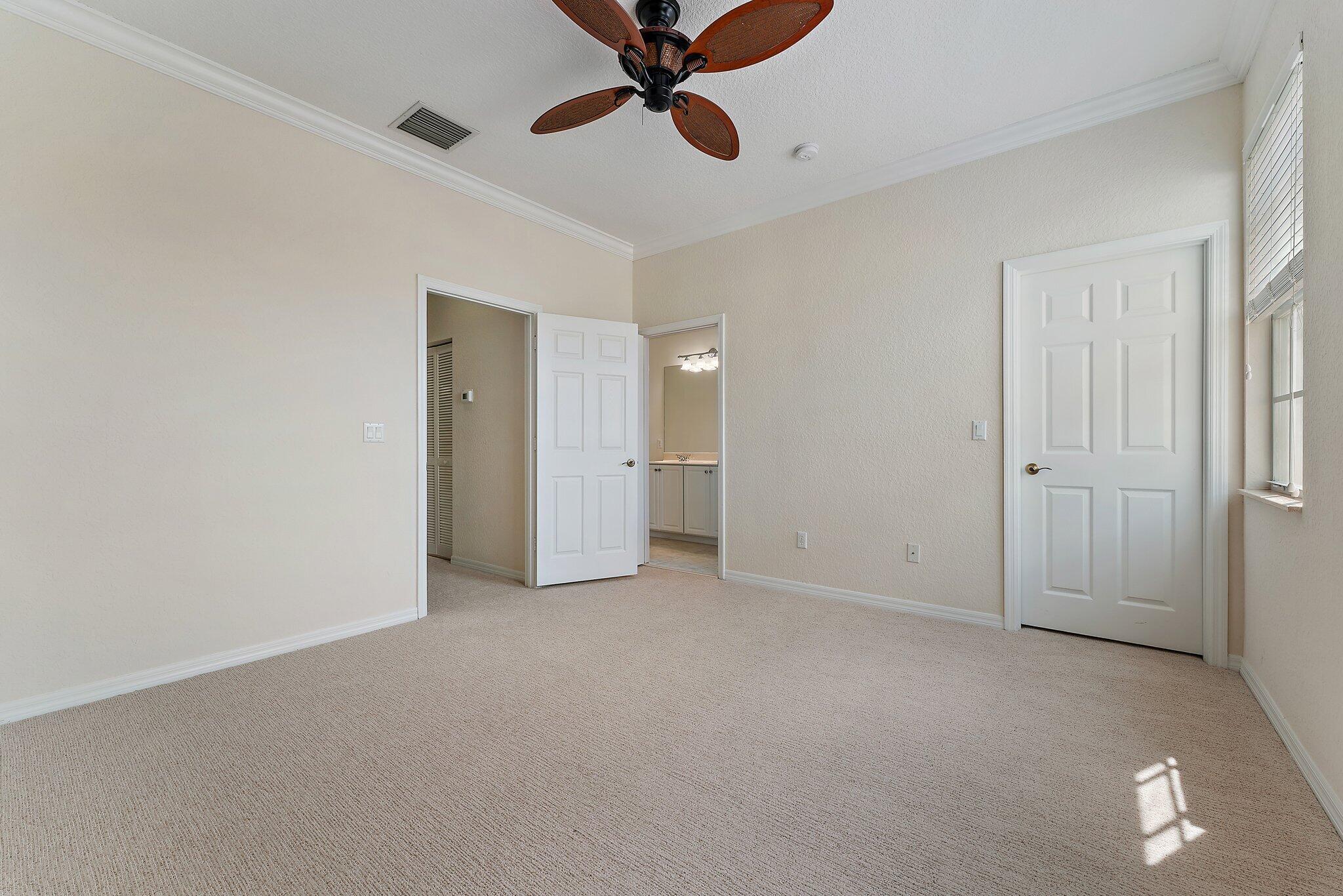 128 West Thatch Palm Circle Jupiter, FL 33458 - Photo 19 of 31 a view of an empty room and chandelier fan