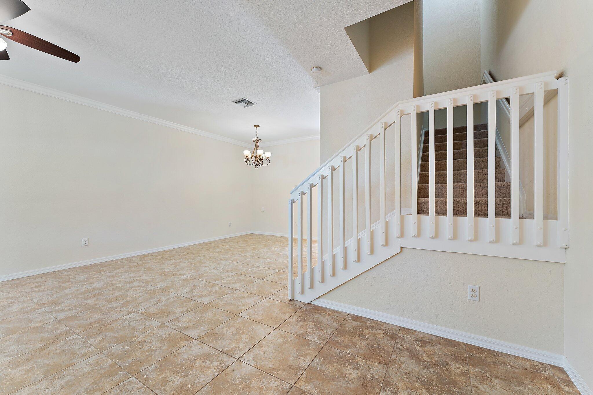 128 West Thatch Palm Circle Jupiter, FL 33458 - Photo 4 of 31 a view of a hallway with staircase