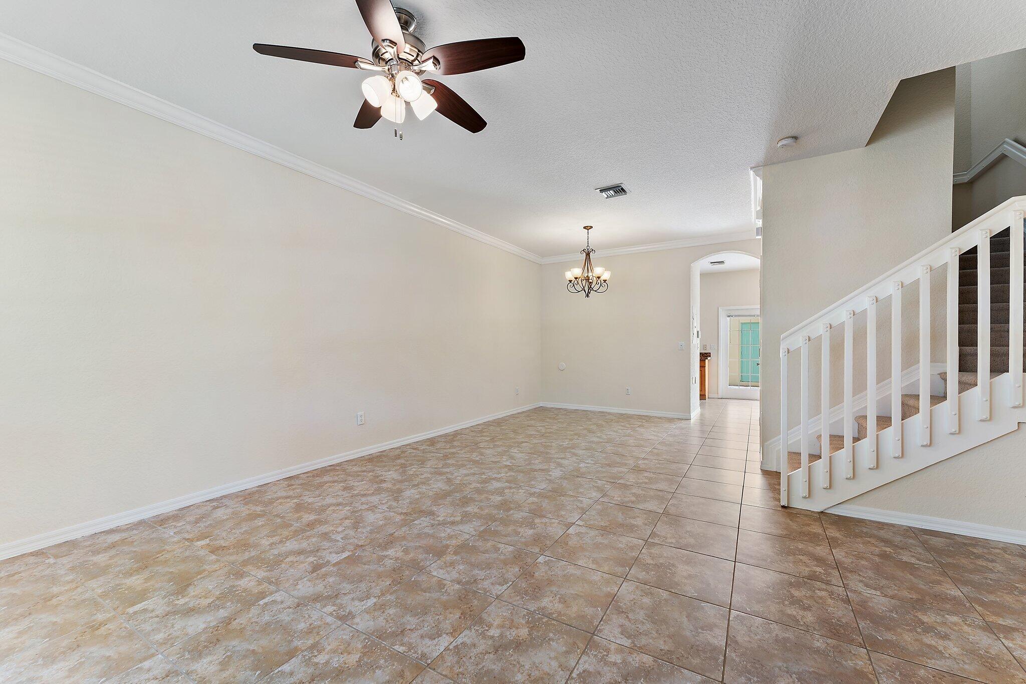 128 West Thatch Palm Circle Jupiter, FL 33458 - Photo 5 of 31 en empty room with ceiling fan and window