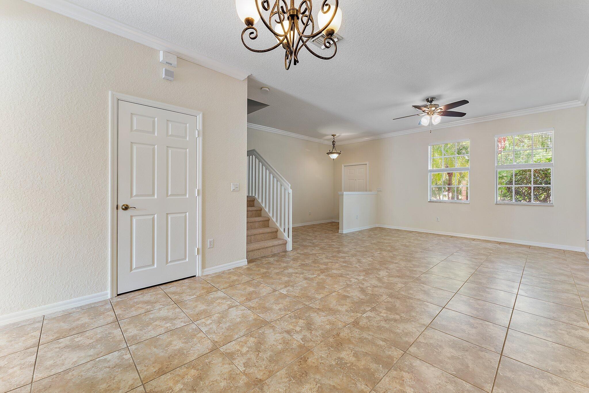 128 West Thatch Palm Circle Jupiter, FL 33458 - Photo 7 of 31 an empty room with windows and fan