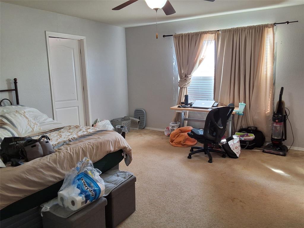 112 Hancock Street Venus, TX 76084 - Photo 21 of 25 Carpeted room with a ceiling fan, a window featuring horizontal blinds and curtain rods, and a white paneled door