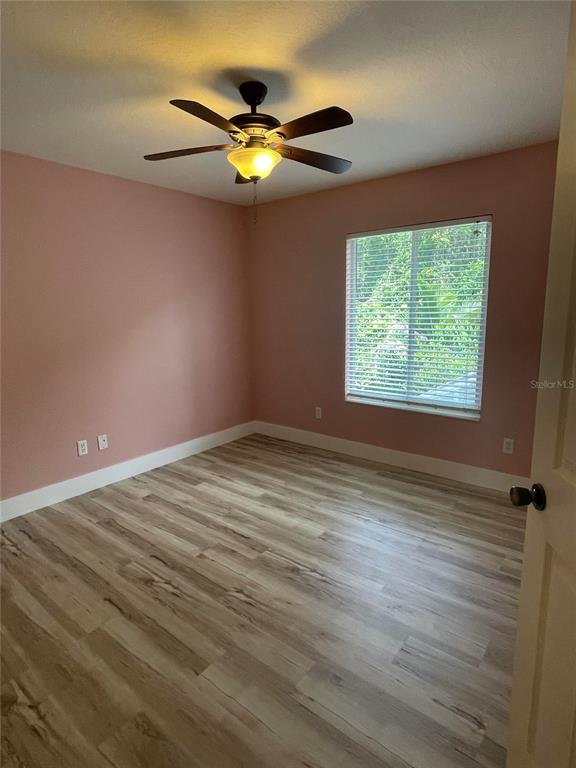 759 Fordingbridge Way Osprey, FL 34229 - Photo 21 of 51 an empty room with window and wooden floor