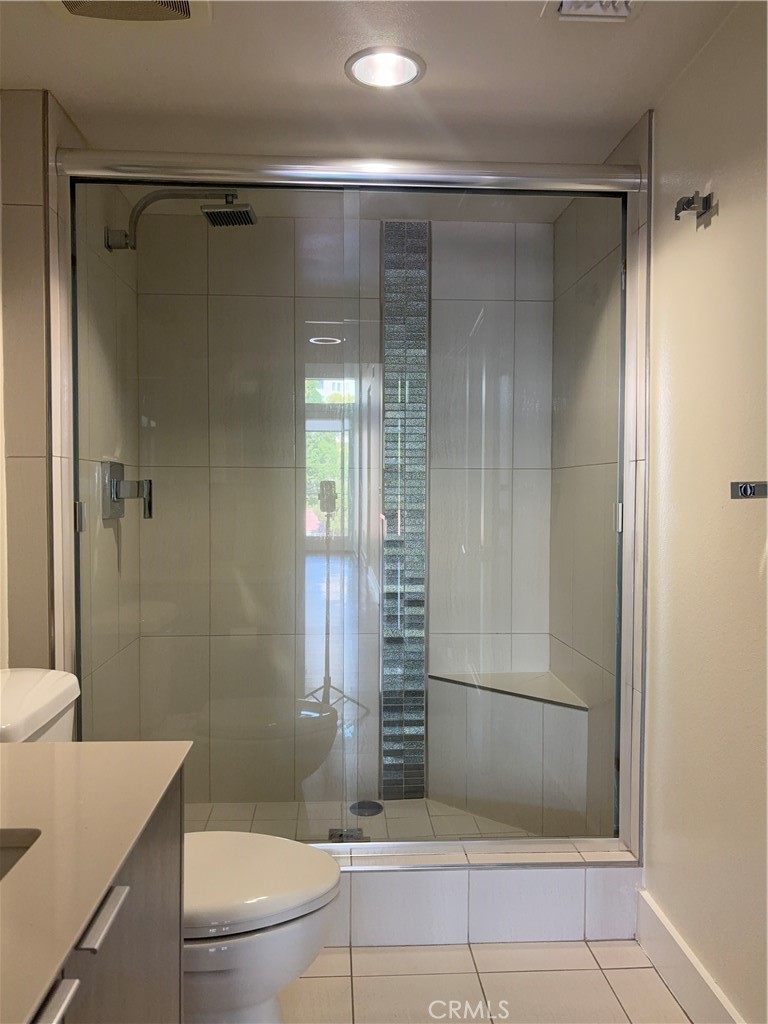 600 Ridgeley Drive Los Angeles, CA 90036 - Photo 15 of 29 a bathroom with a shower and a toilet