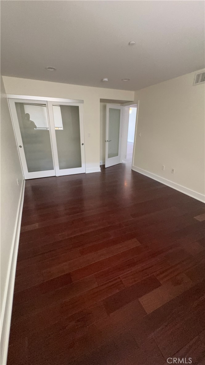 600 Ridgeley Drive Los Angeles, CA 90036 - Photo 17 of 29 a view of an empty room with wooden floor and windows