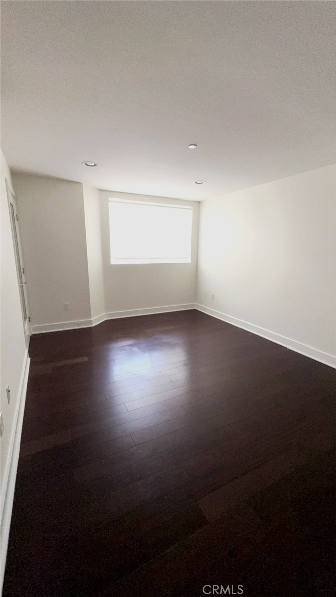 600 Ridgeley Drive Los Angeles, CA 90036 - Photo 21 of 29 a view of room with hardwood floor and window