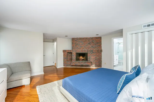 a bedroom with a bed and a fireplace