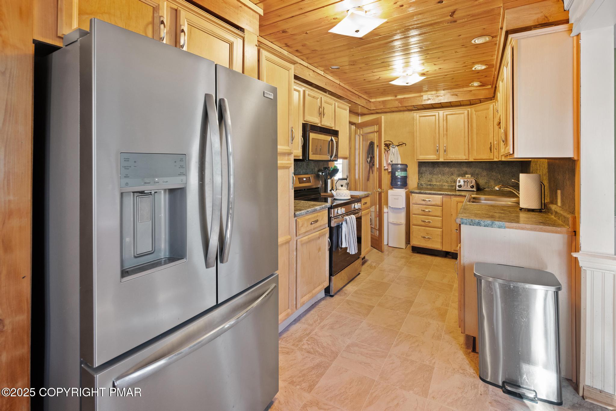 165 Sweet Briar Road Pocono Pines, PA 18350 - Photo 11 of 39 a kitchen with stainless steel appliances granite countertop a refrigerator and a stove