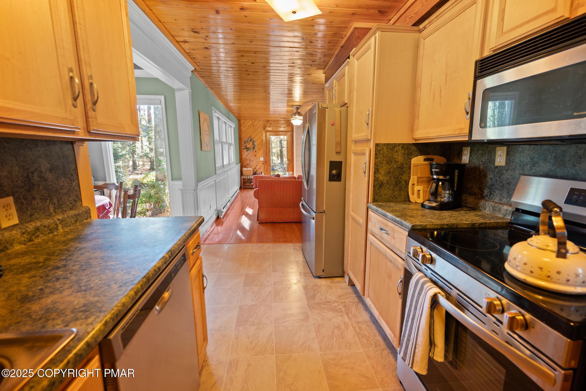 165 Sweet Briar Road Pocono Pines, PA 18350 - Photo 14 of 39 a kitchen with stainless steel appliances granite countertop a sink a stove and a wooden floors