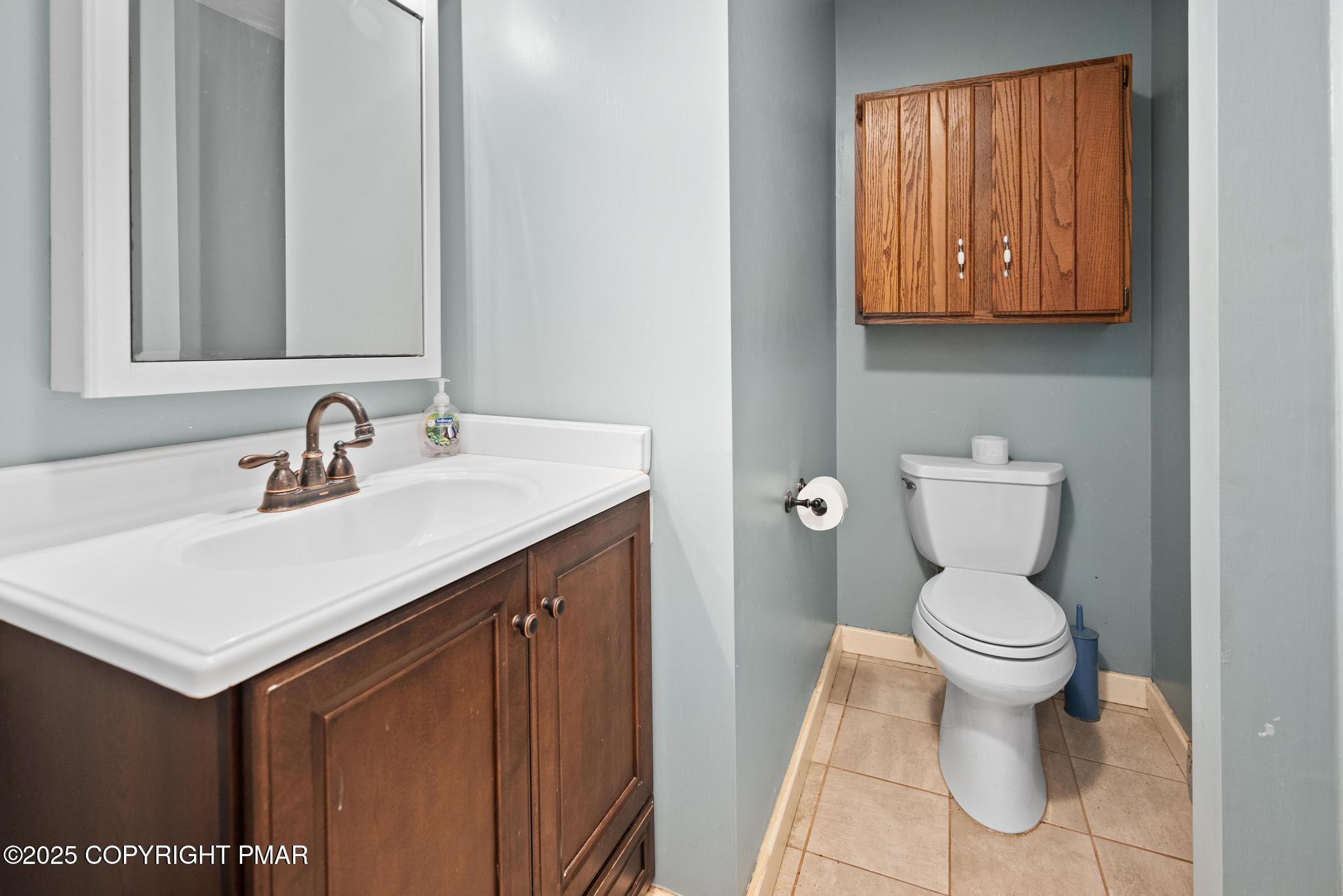 165 Sweet Briar Road Pocono Pines, PA 18350 - Photo 17 of 39 a bathroom with a sink toilet and a mirror