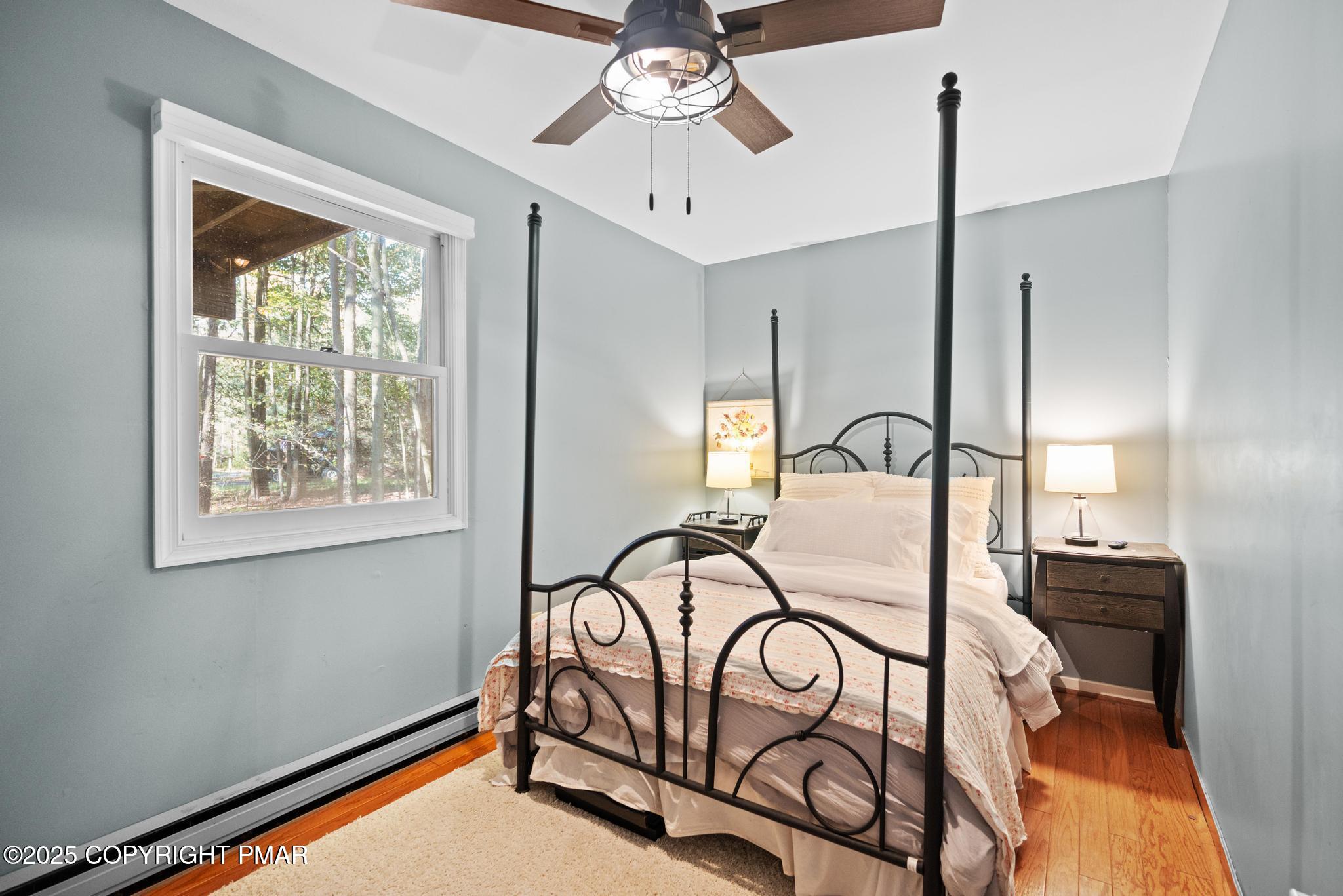 165 Sweet Briar Road Pocono Pines, PA 18350 - Photo 19 of 39 a bedroom with a bed and a chandelier