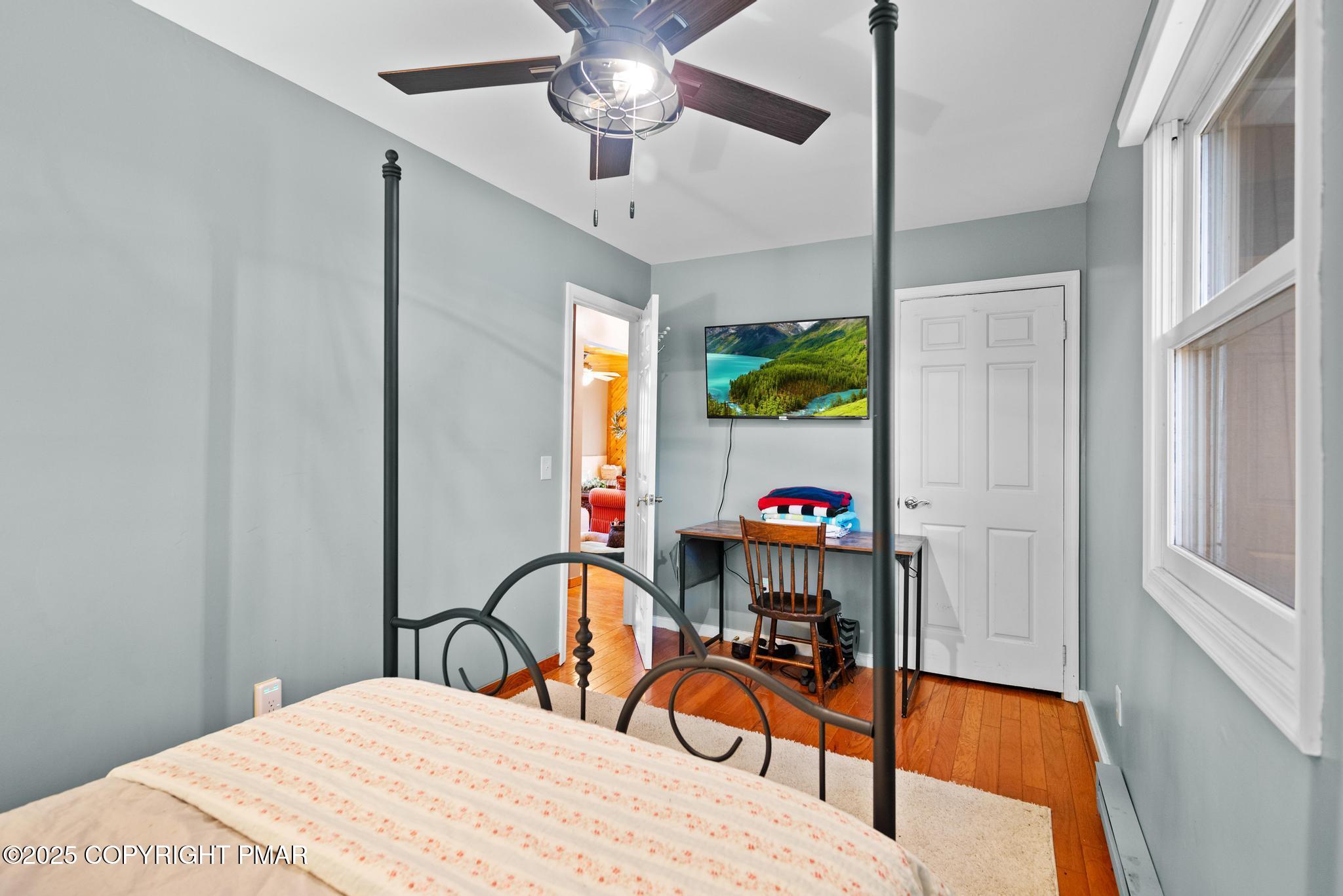 165 Sweet Briar Road Pocono Pines, PA 18350 - Photo 20 of 39 a bedroom with a bed a chandelier and a window