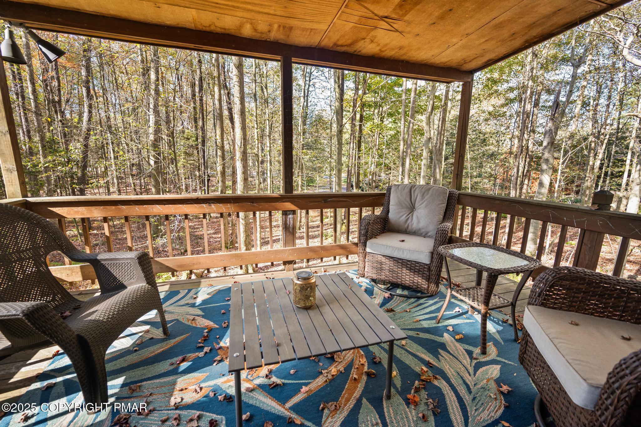 165 Sweet Briar Road Pocono Pines, PA 18350 - Photo 23 of 39 a view of a patio with lawn chairs and wooden floor