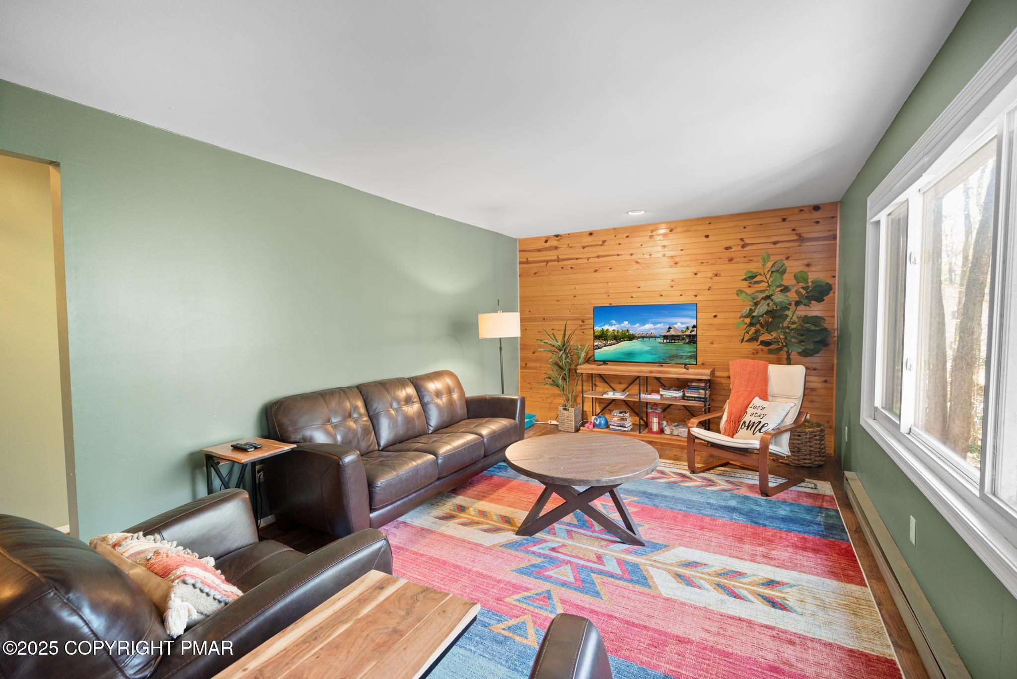 165 Sweet Briar Road Pocono Pines, PA 18350 - Photo 25 of 39 a living room with furniture a rug and a large window