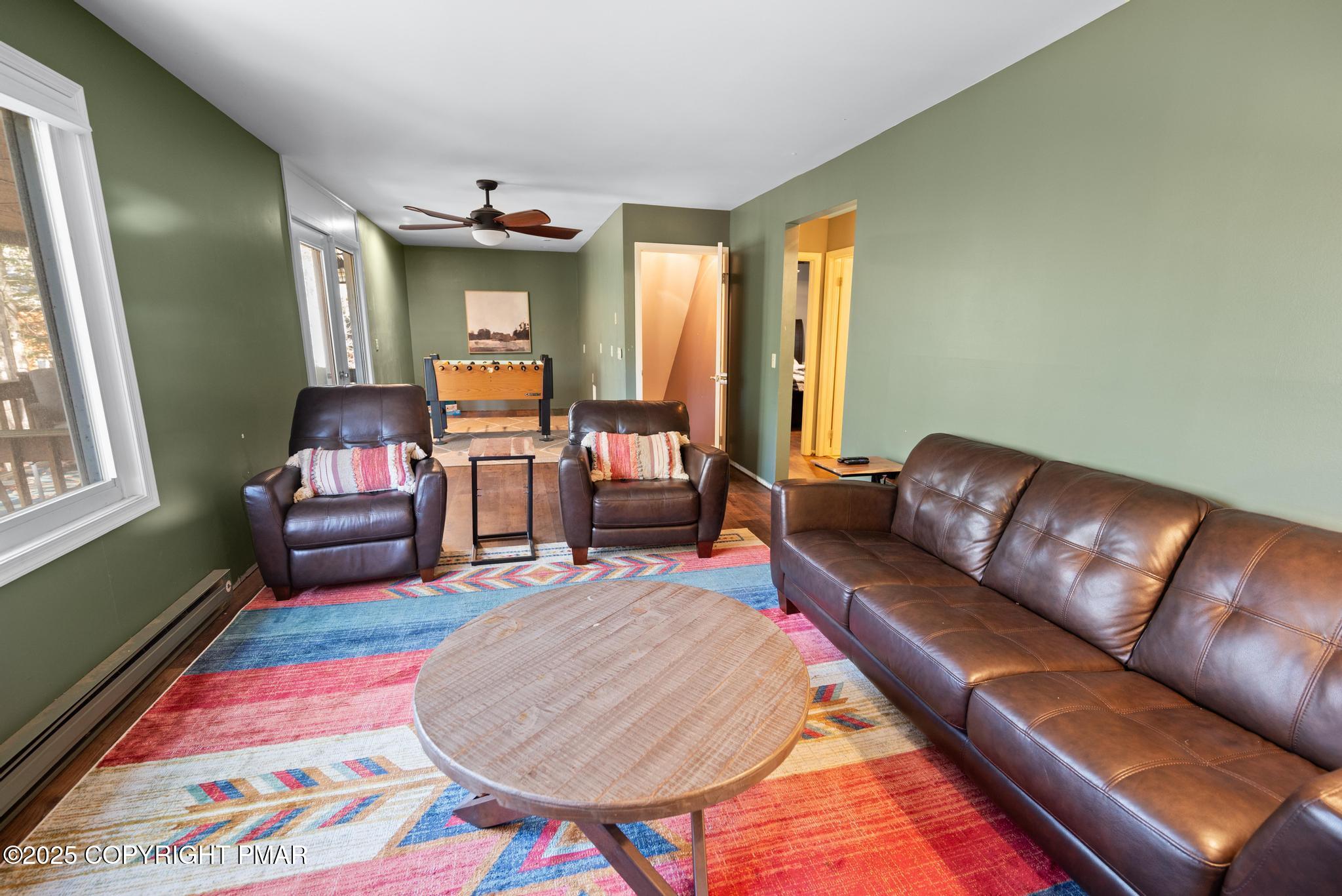 165 Sweet Briar Road Pocono Pines, PA 18350 - Photo 27 of 39 a living room with furniture and a chair