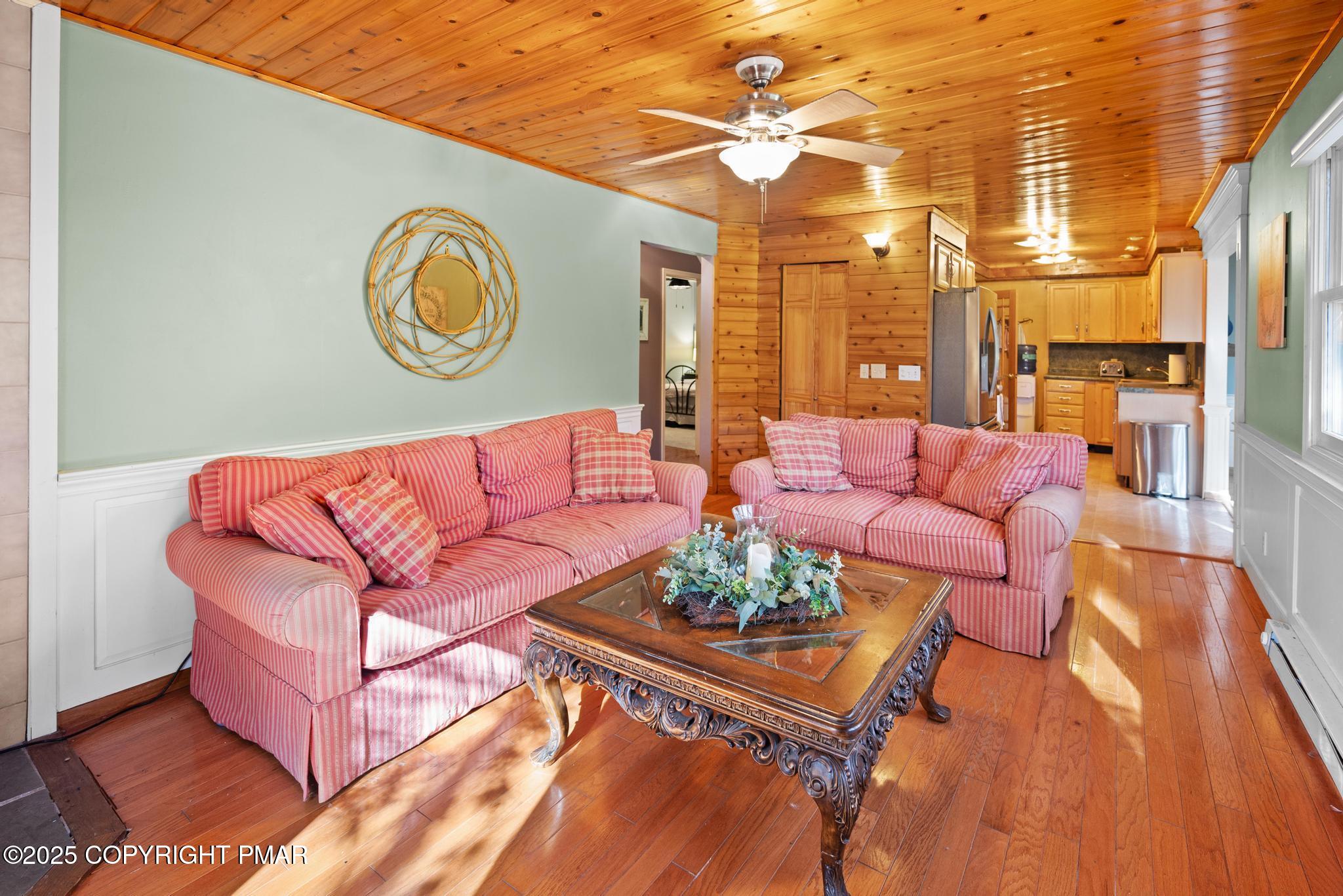 165 Sweet Briar Road Pocono Pines, PA 18350 - Photo 9 of 39 a living room with furniture and a chandelier