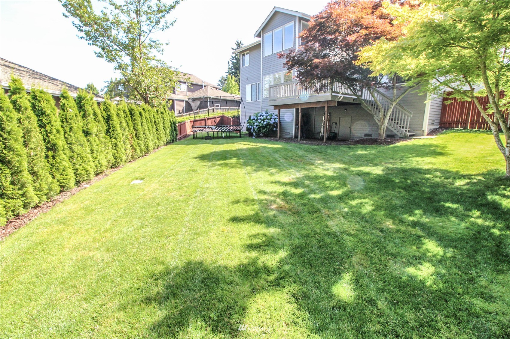 23539 14th Drive Southeast Bothell, WA 98021 - Photo 23 of 23 a view of yellow house with a big yard and large trees