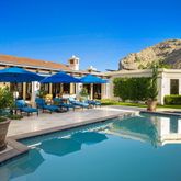 a view of a house with garden and patio