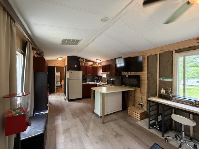 2795 East 28th Road Marseilles, IL 61341 - Photo 5 of 58 a kitchen with stainless steel appliances kitchen island granite countertop a refrigerator a stove a sink dishwasher a dining table and chairs with wooden floor