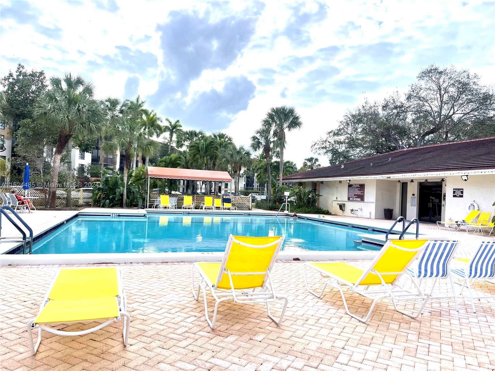 a view of swimming pool with sitting area