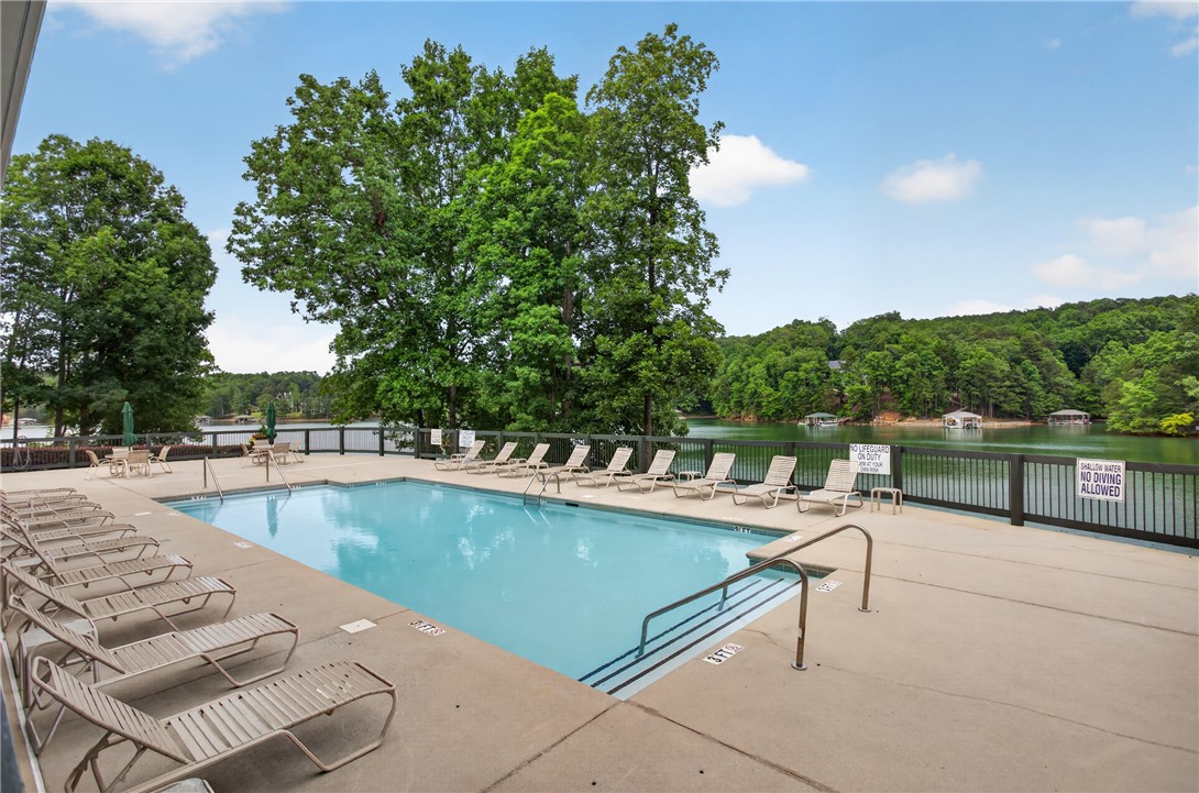 1230 Melton Road, Unit 4 West Union, SC 29696 - Photo 8 of 48 Enjoy lakeside living with a crystal-clear pool, offering refreshing dips and scenic views.