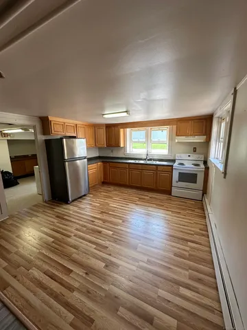 a room with wooden floor and furniture