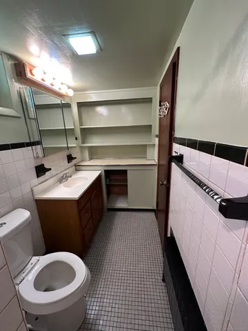 a bathroom with a sink toilet and mirror
