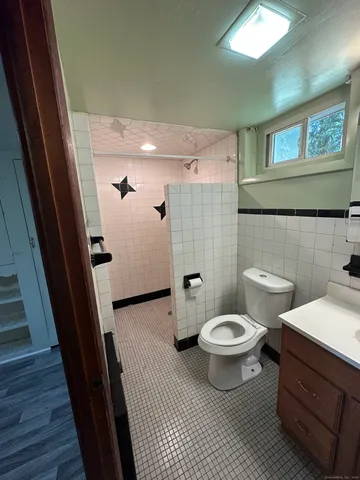 a bathroom with a toilet and a shower