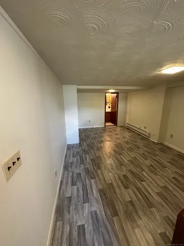 a view of a room with wooden floor