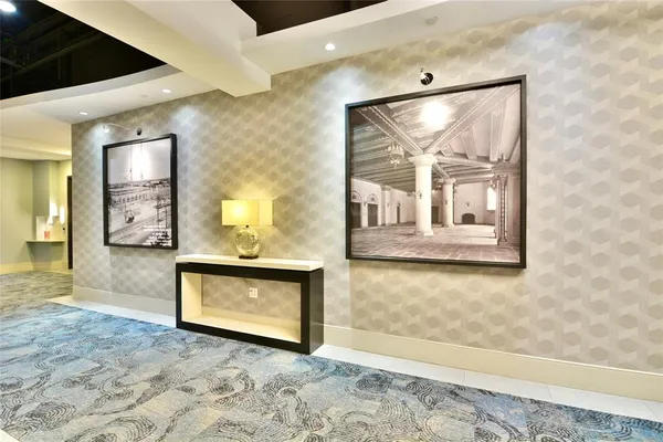 a view of a hallway with wooden floor and a living room