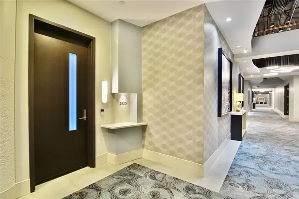 a view of a hallway with furniture and a rug