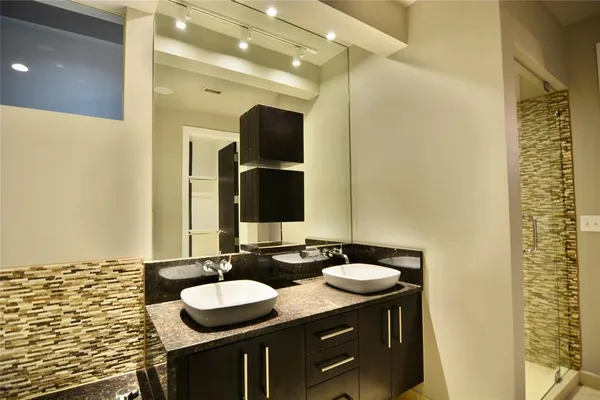 a bathroom with a granite countertop sink and a mirror