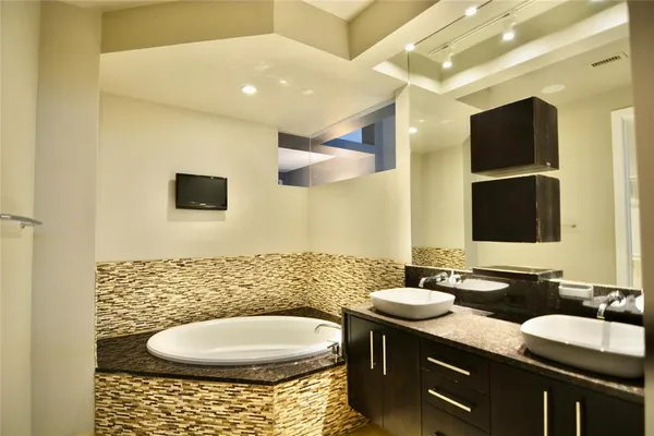 a bathroom with a sink a toilet and mirror