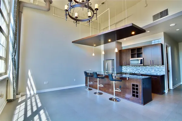 a kitchen with stainless steel appliances granite countertop a stove and a wooden cabinets