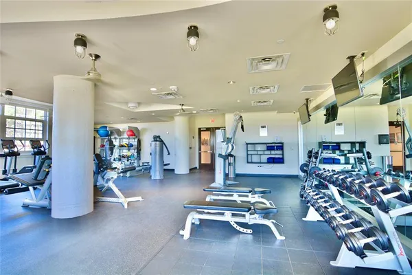 a gym room with lots of furniture and clutter