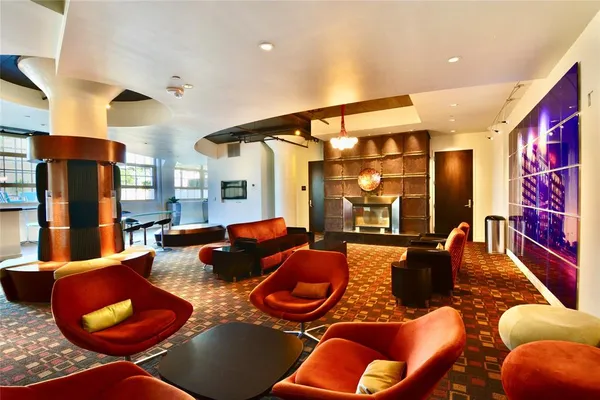 a living room with furniture kitchen view and a large window