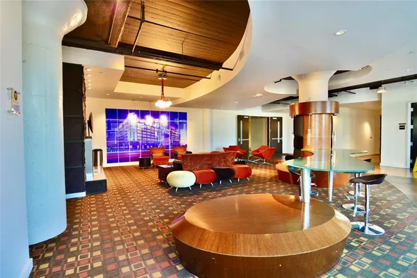 a room with wooden floors and pool table