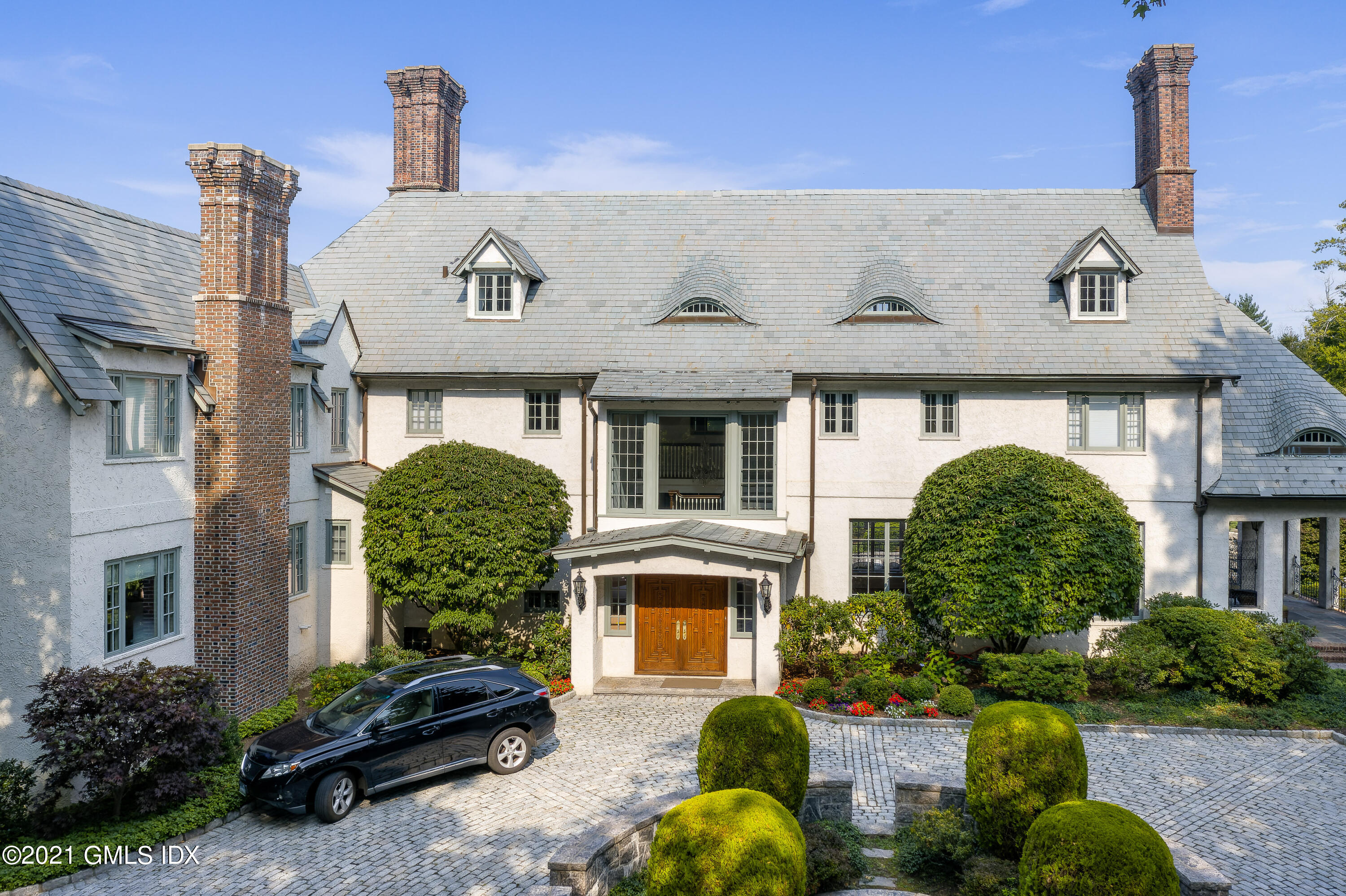 a front view of a house with garden